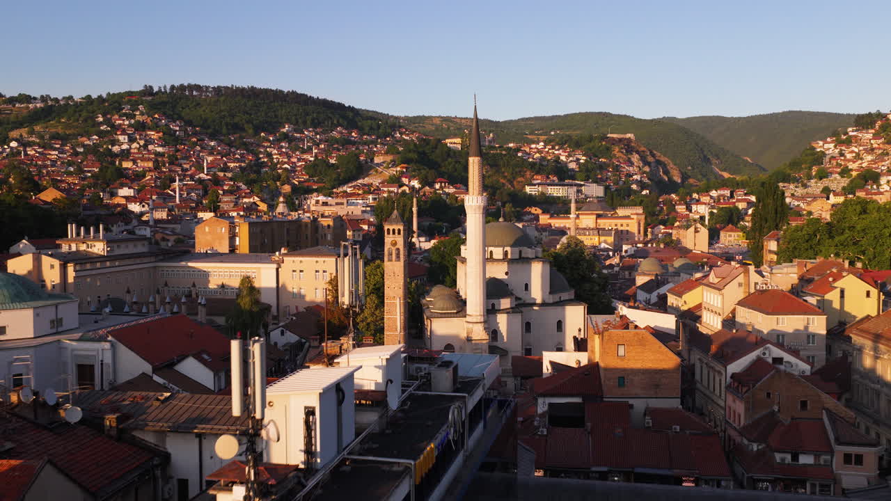 Flying Through Sarajevo Skyline At Sunset With Gazi Husrev-beg Mosque And Historic Buildings In View. drone shot