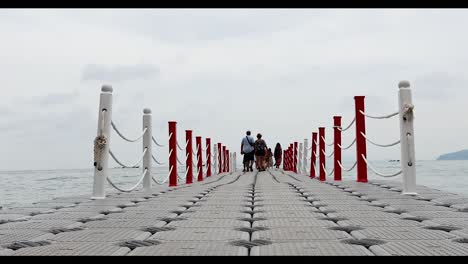 people walking on a floating pier in krabi