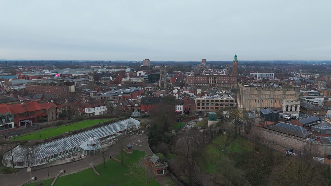 A scenic aerial view of Norwich, showcasing historic churches, turrets, and shops