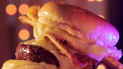 juicy burger with crispy bacon spinning slowly in ad-like clip, close up view