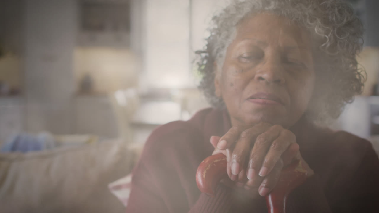 Animation of glowing light over pensive senior woman