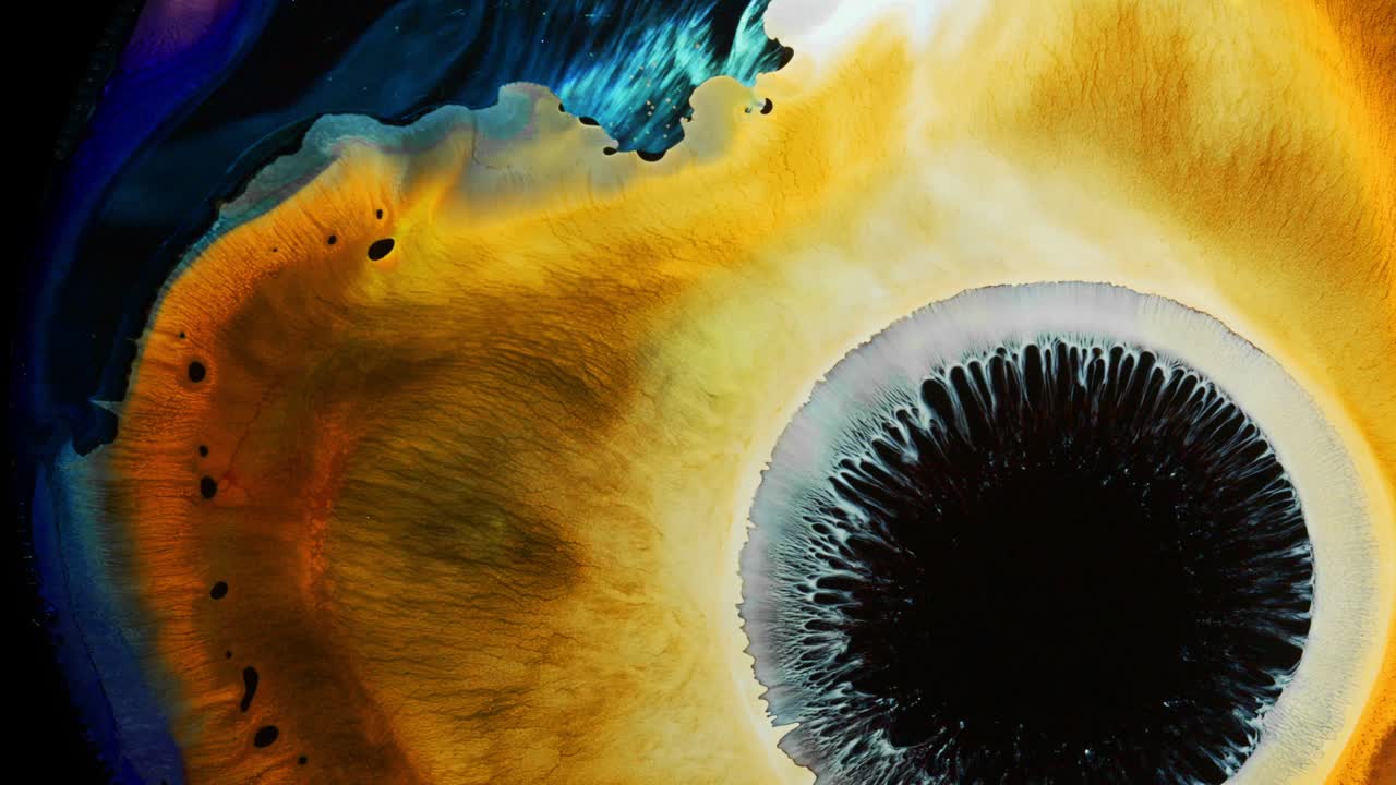 reacción amarilla y azul brillante con tinta líquida el big bang de la supernova