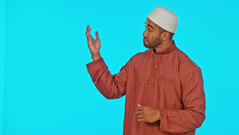 pointing, face and muslim man in a studio