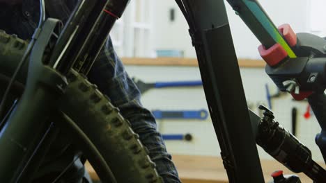 man repairing bicycle in workshop 4k