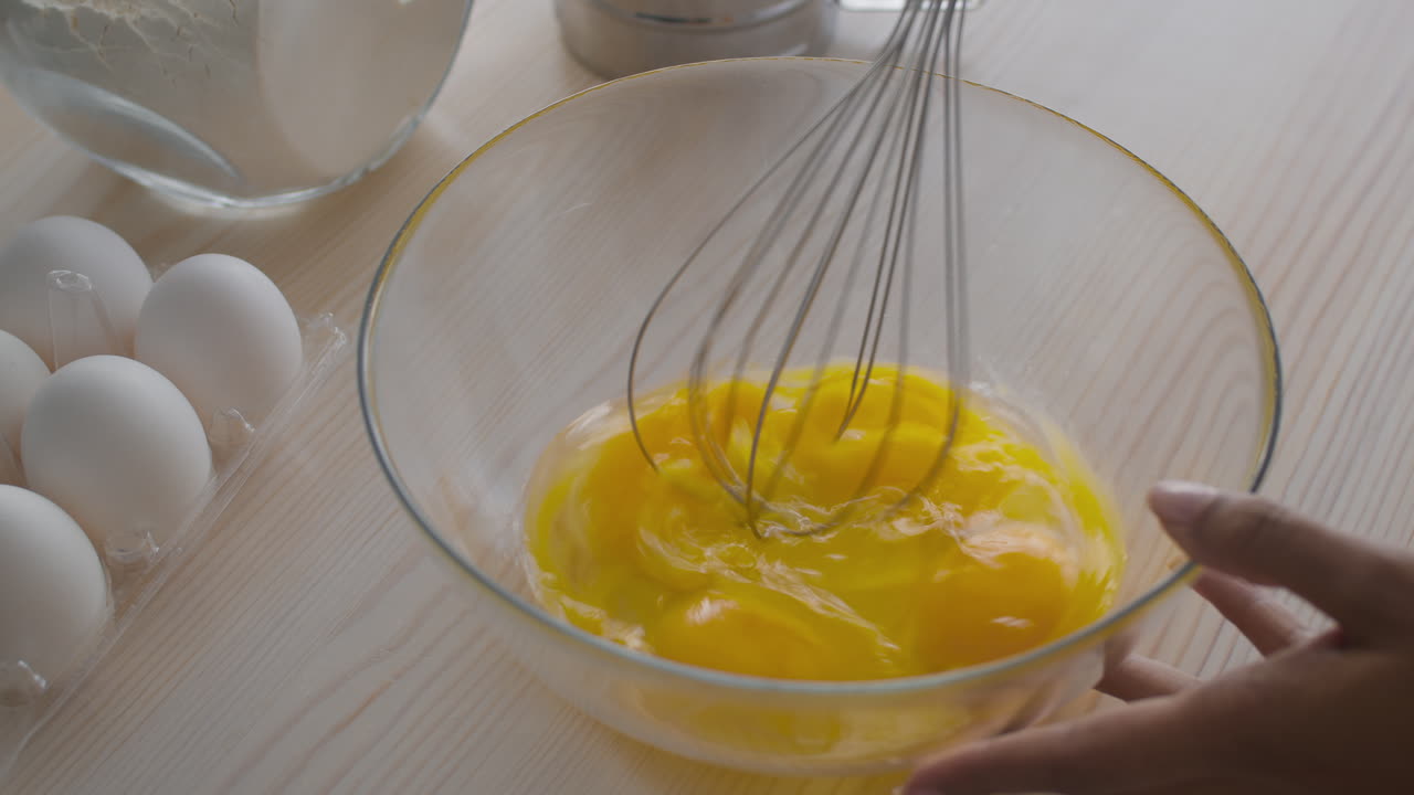 Mixing Eggs in a Bowl for Baking