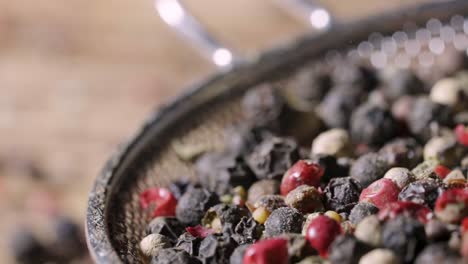 mixed peppercorns in a strainer