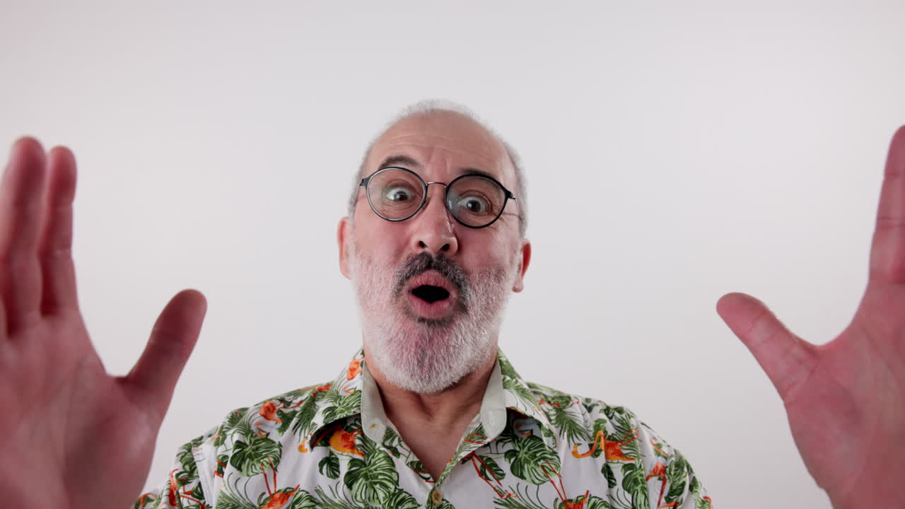 Surprised man in tropical shirt with hands raised