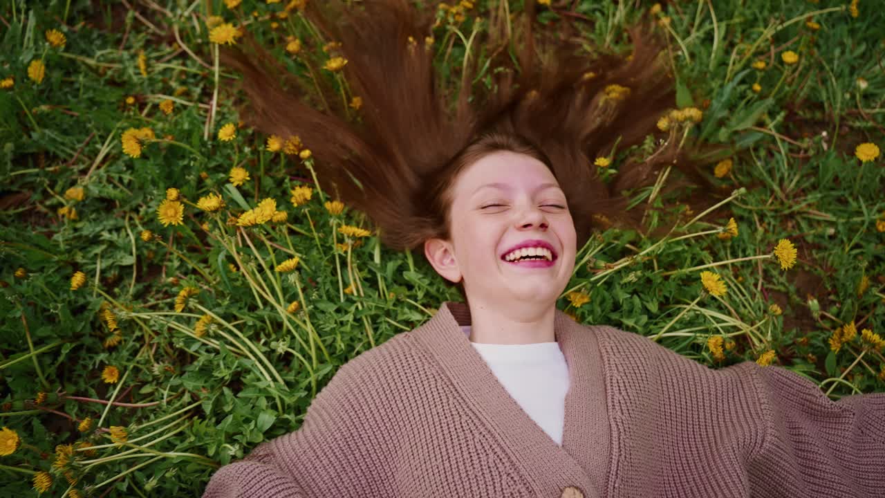Girl Lying on Grass with Dandelions