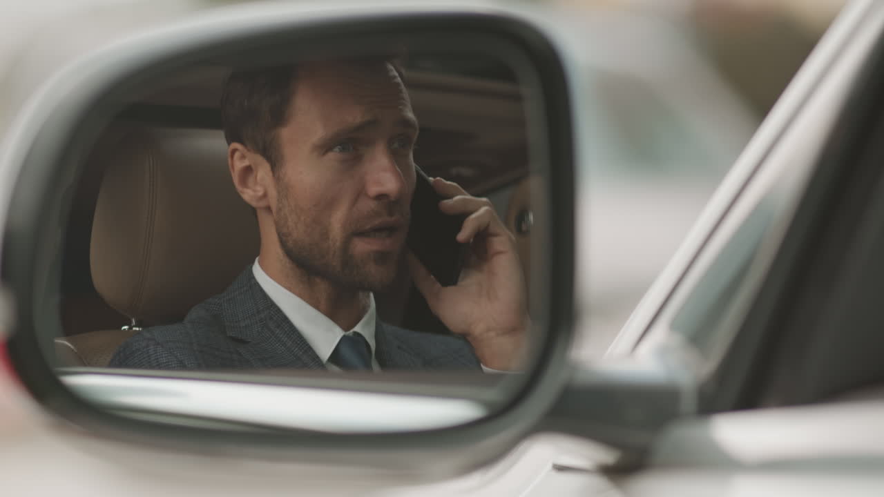 Reflection of Caucasian Man in Side Mirror