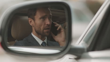 reflection of caucasian man in side mirror