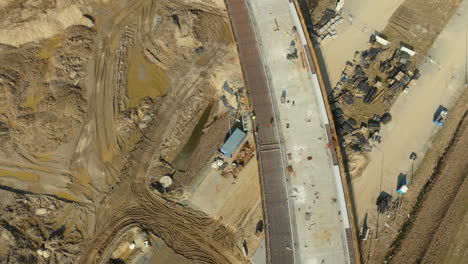 worker on construction site on highway during sunny day