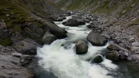 a river with rapids flows through a rocky mountain valley