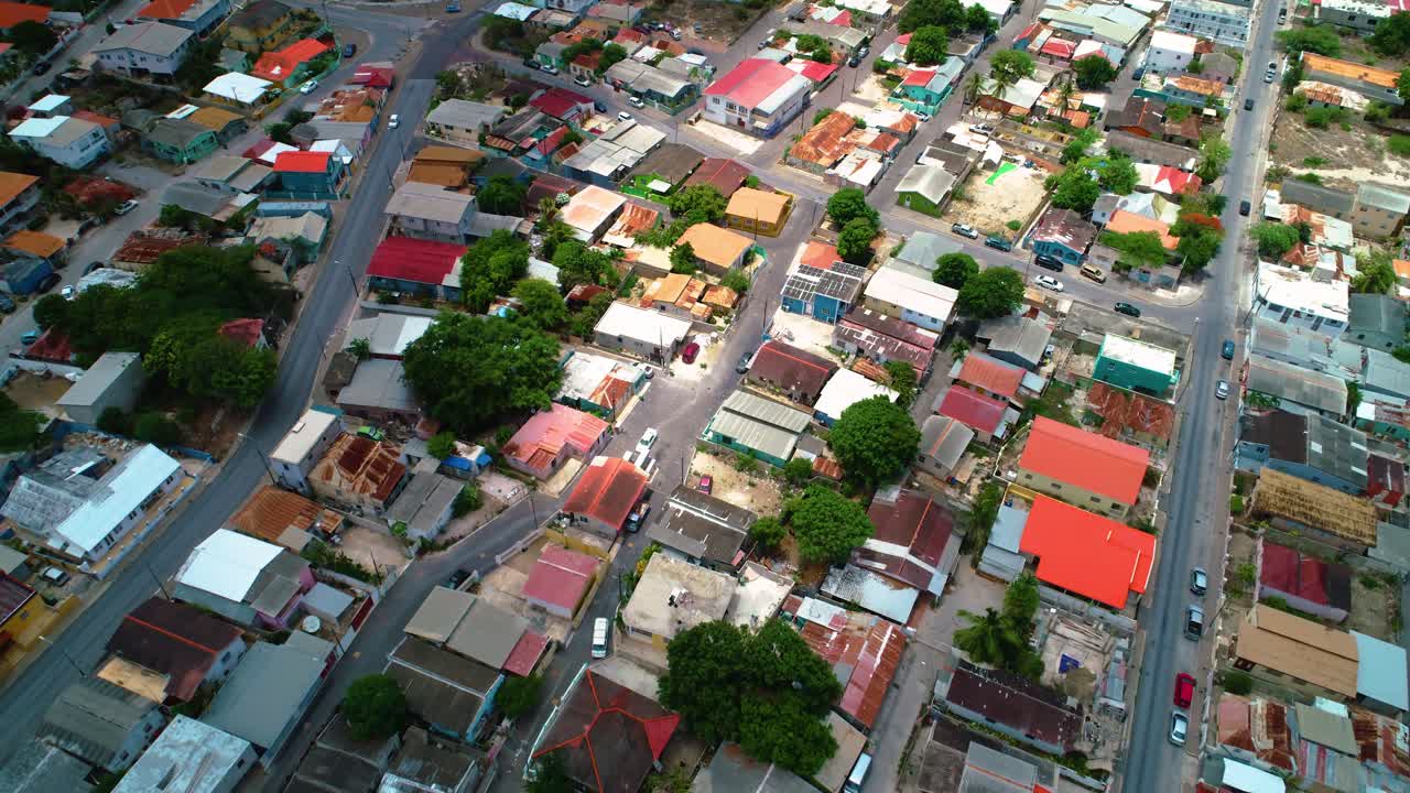 Drone bird's eye view of Willemstad small poor houses as cloud shadow moves across slums
