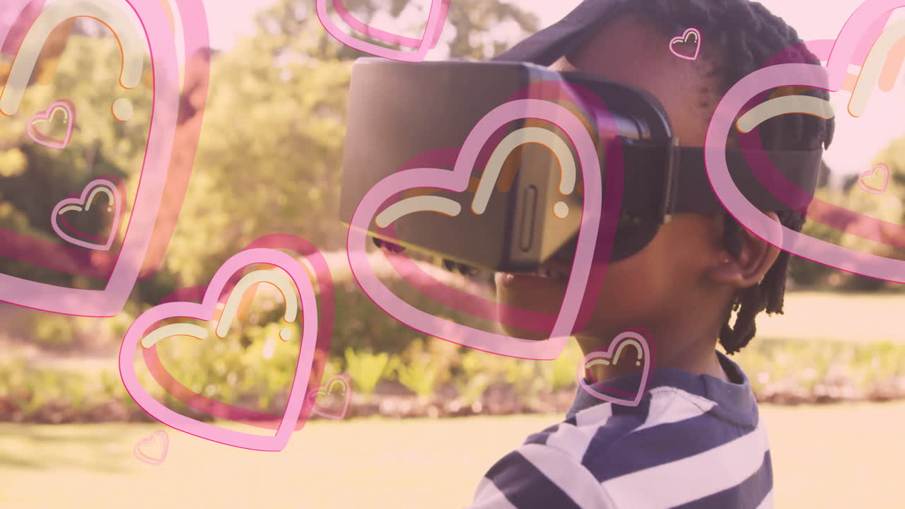 Wearing VR headset, child with animated hearts overlay in school playground
