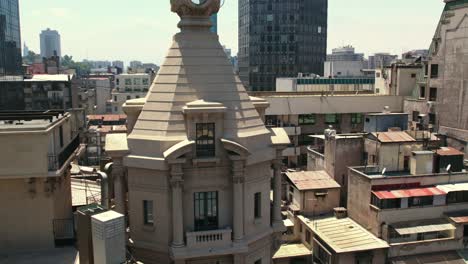 aerial view dolly in from the balcony at the top of the ariztia building on nueva york street in santiago, chile