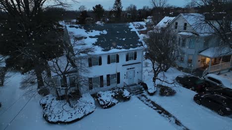 abandoned house in suburb of small town during snowfall in usa