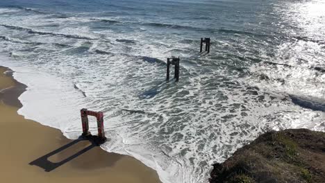 pedestal shot of the broken down davenport pier and pacific coast on highway one in northern california