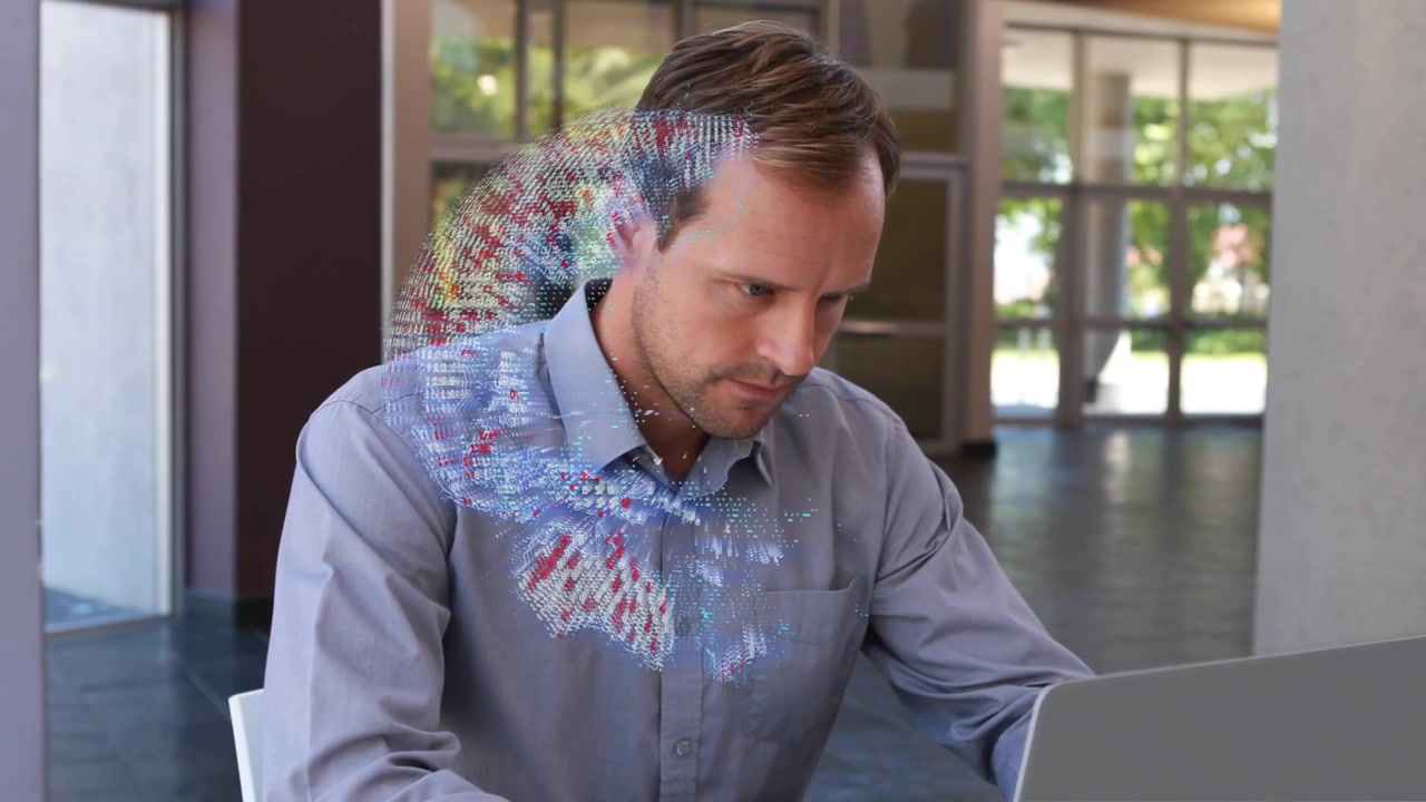 Man writing clipboard glancing laptop, 3D globe appearing drifting over chest, typing business data