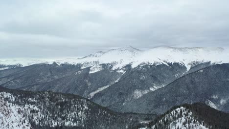 drone fly over fir mountains deeply covered with snow at winter park in colorado rocky mountains. - aerial shot