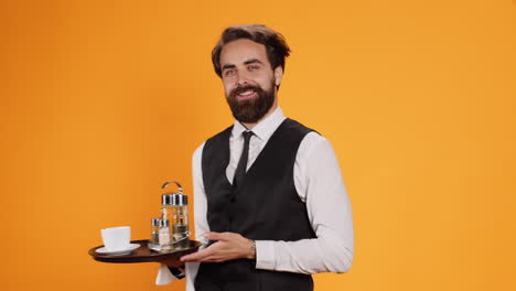 confident waiter poses with tray in hand