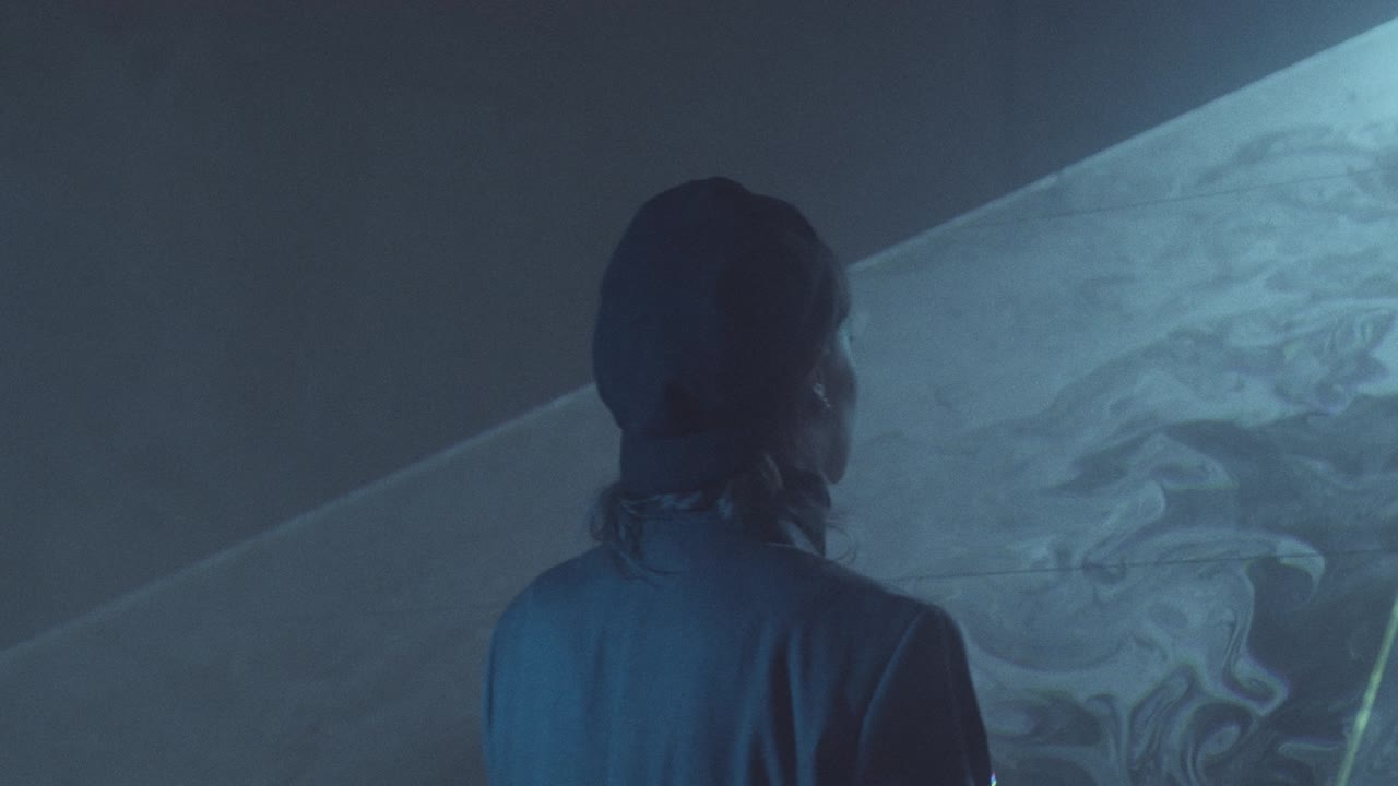 Woman Going through Flat Sheet of Laser Light in Dark Studio