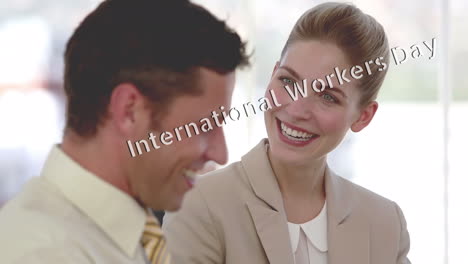 Animation of international workers day text moving over caucasian business people in office