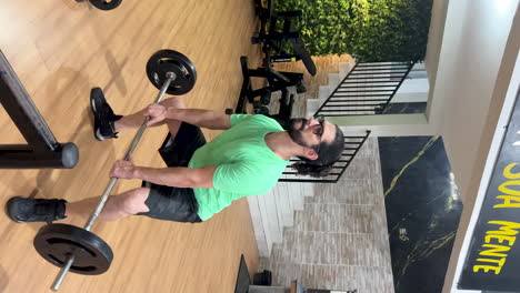 Latin-man-with-beard-and-long-hair-performing-barbell-squat-exercise