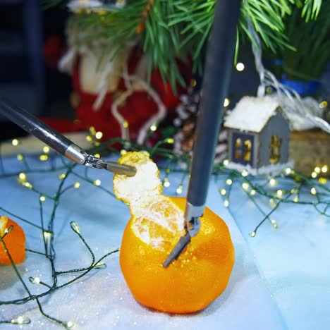minimal invasive surgical equipment used for peeling tangerines. possibilities of delicate work of innovative surgical technologies