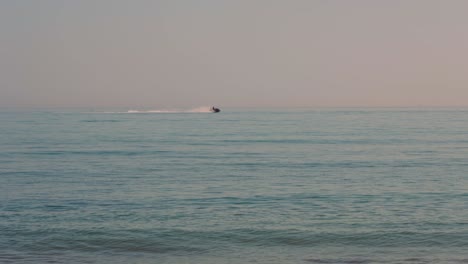 Olas-Del-Océano-Con-Jetski-Pasando-Por-El-Fondo