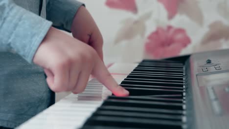 little boy playing on a musical synthesizer 2