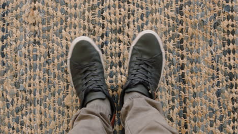 top view man wearing shoes tapping sneakers at home