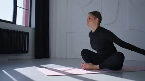 woman doing yoga in a studio