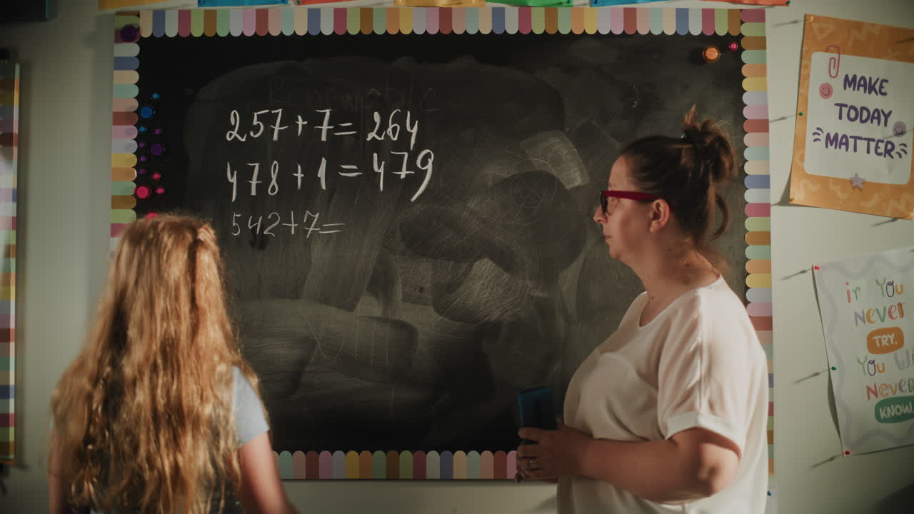 Talented Girl Solving Mathematical Problems on the Board Female Teacher Checking Answers