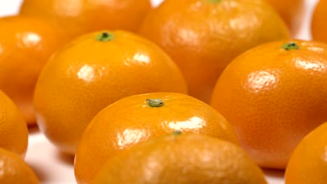 fresh tangerines on a white plate