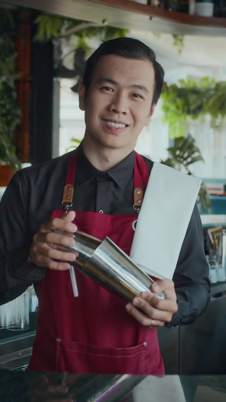 Vertical Portrait of Asian Barman with Cocktails Shaker