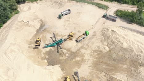 Aerial-view-loading-bulldozer-in-open-air-quarry