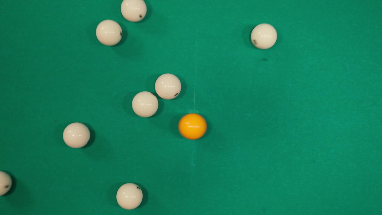 Orange Cue Ball Breaking a Rack of White Billiard Balls