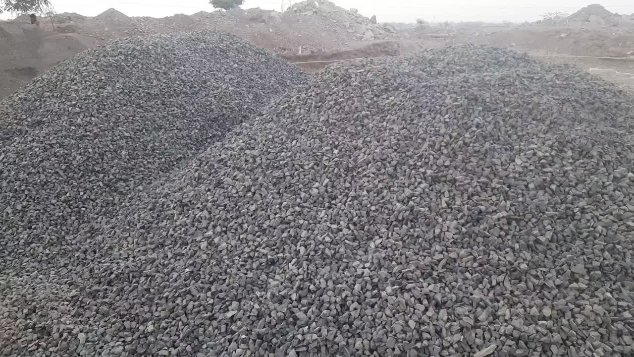 Stone Aggregate Material for Construction. Crushed limestone aggregate. Close up. Gravel of large fractions. Crushed stone, building aggregate, stone structure. Pile of building material