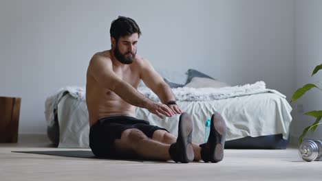 man stretching at home