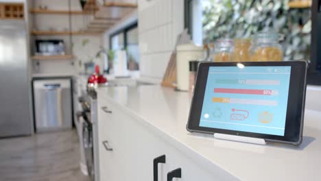 Tablet-with-smart-home-interface-on-white-worktop-in-kitchen,-slow-motion