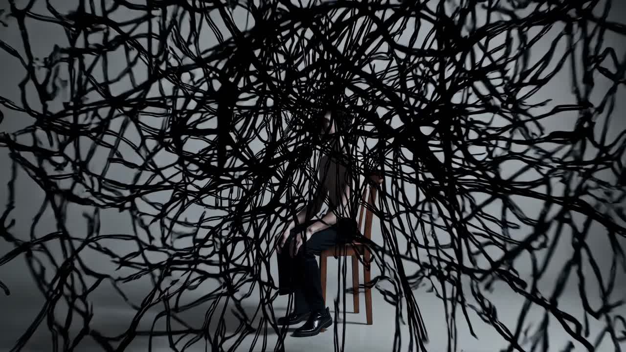 Dark lines spreading from seated man, gradually consuming entire body in complex surreal visualization of psychological struggle against overwhelming mental states on neutral gray background