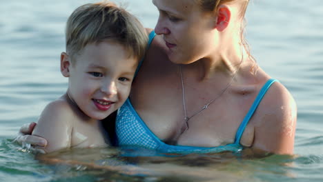 Son-and-mother-bathing-in-sea