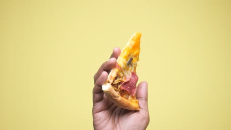 handheld slice of pizza
