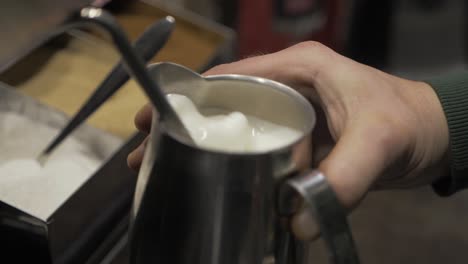 milk being frothed at a diner for a customers morning cup of coffee