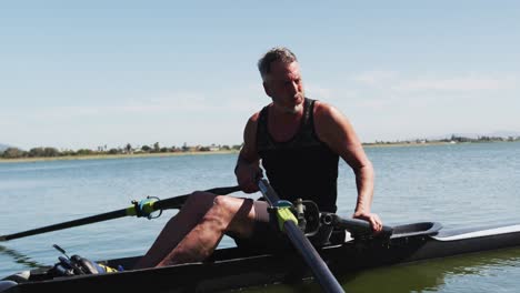 Senior-caucasian-man-preparing-rowing-boat-in-a-river