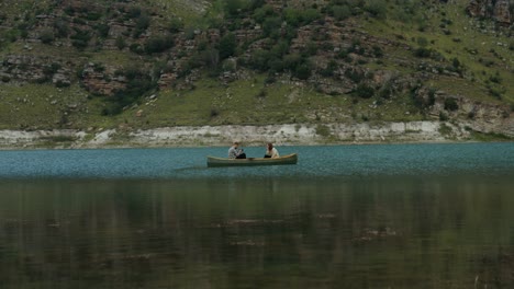 two people canoeing on a serene lake