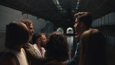 Rear-view-of-a-brunette-girl-with-curly-hair-falls-into-the-hands-of-group-therapy-participants-during-trust-practice