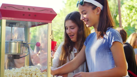 teen girls serving popcorn at a neighbourhood block party