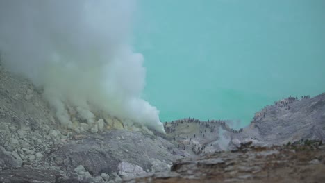 acid lake ijen sulfur plume toxic smoke volcano caldera nature tourist attraction indonesia