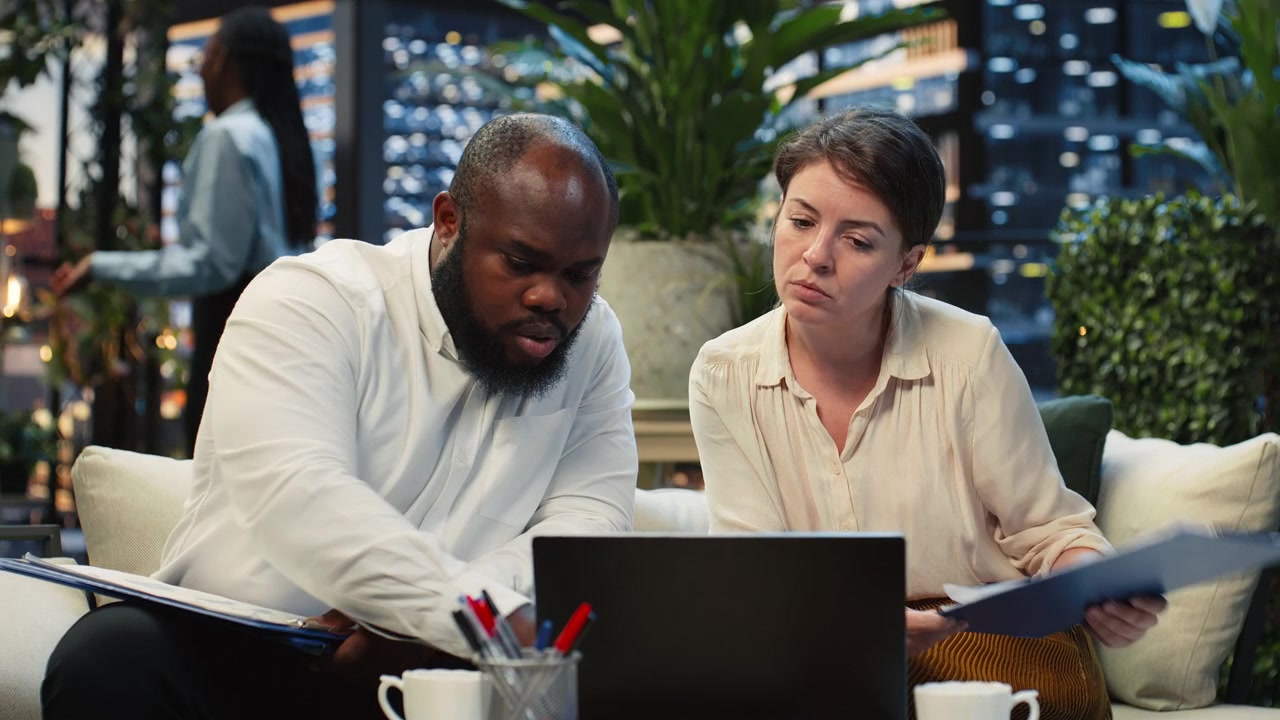 Close up of businesspeople analyzing laptop information together
